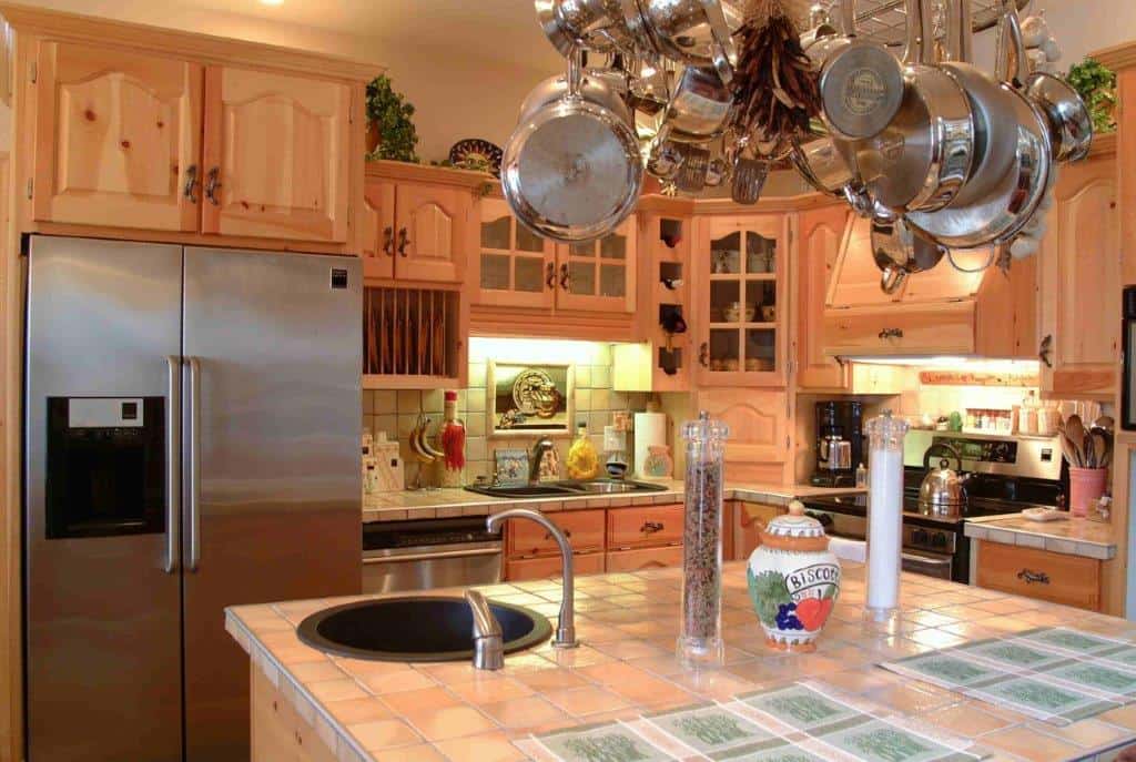 Bright kitchen with wooden cabinets and modern appliances in Englishtown, Nova Scotia.