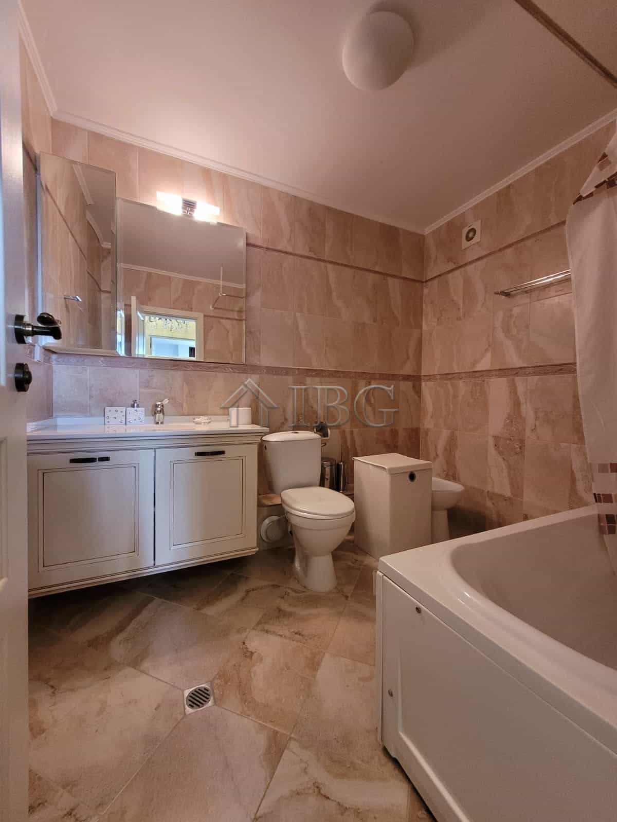 Elegant bathroom featuring a bathtub, toilet, and vanity in a high-end Sveti Vlas maisonette.