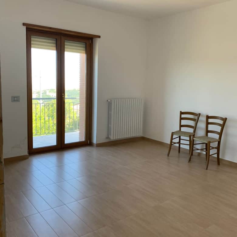Spacious interior of a 3-bedroom house in Orsara di Puglia with large balcony and natural light.
