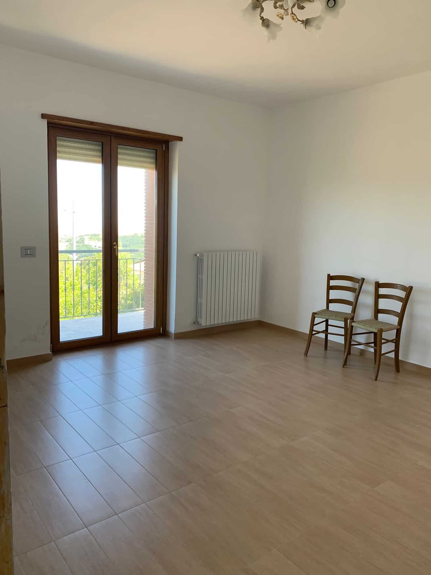 Spacious interior of a 3-bedroom house in Orsara di Puglia with large balcony and natural light.