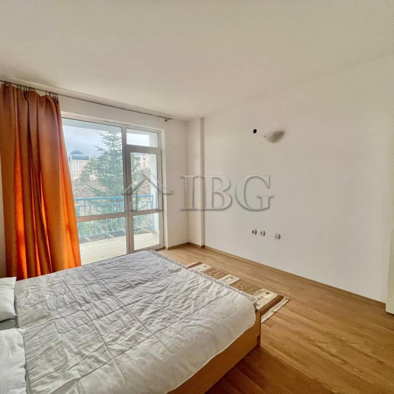 Bright bedroom with large window and balcony overlooking green area in Sveti Vlas.