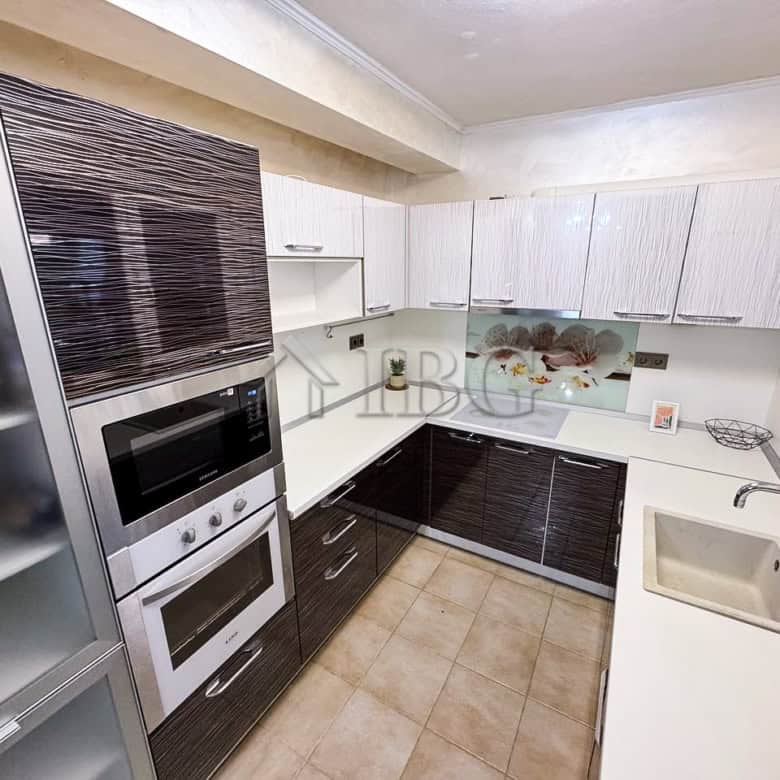 Bright kitchen with sea views, modern cabinetry, and appliances in Victoria Hill property.