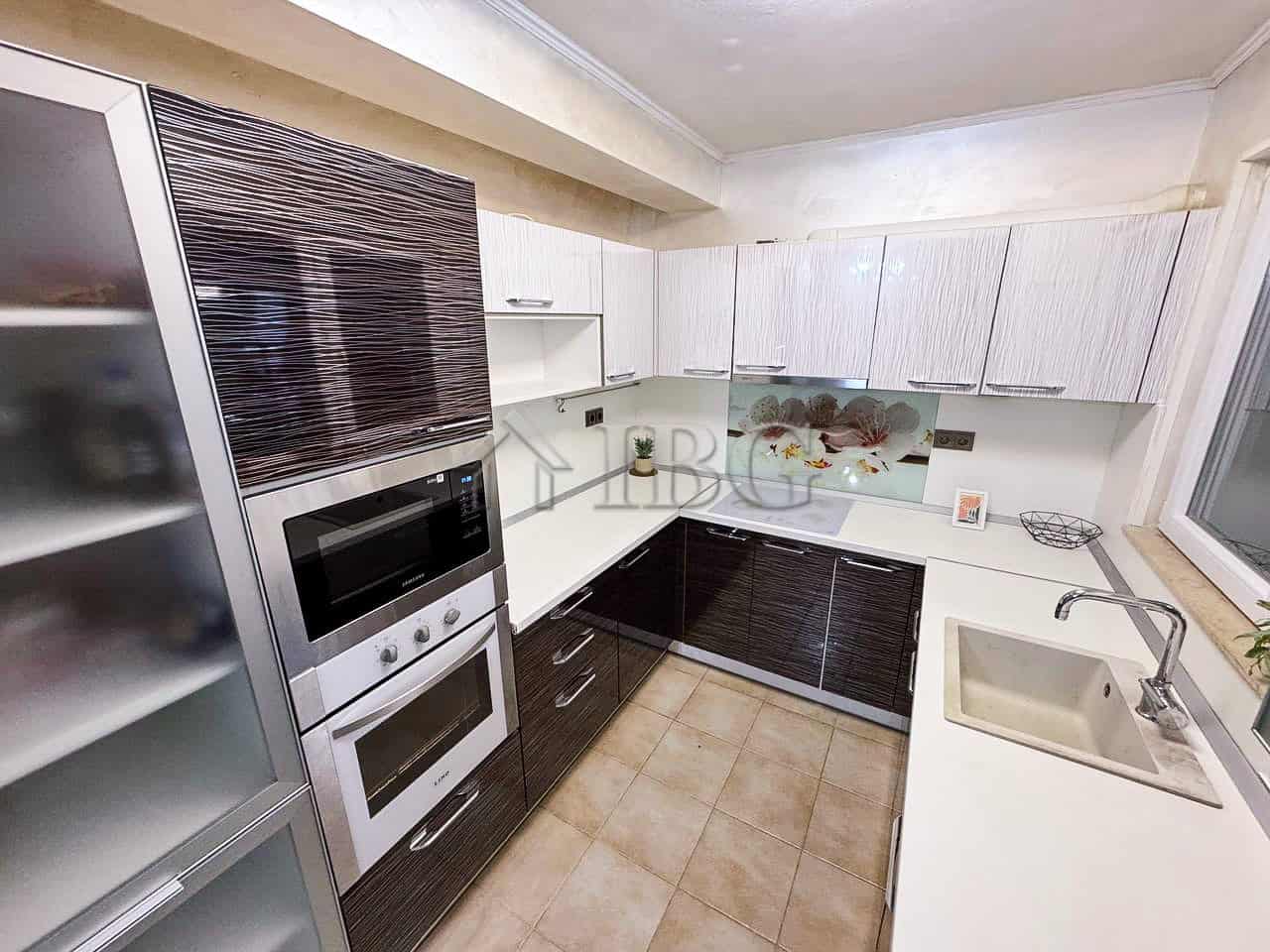 Bright kitchen with sea views, modern cabinetry, and appliances in Victoria Hill property.