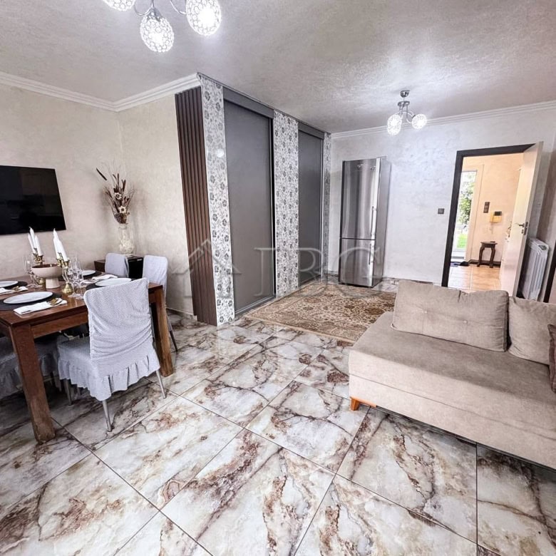 Spacious interior featuring a comfortable sofa, dining table, and elegant decor.