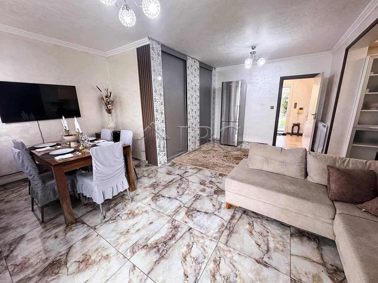 Spacious interior featuring a comfortable sofa, dining table, and elegant decor.