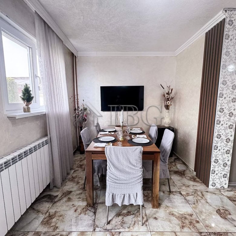 Bright dining area overlooking the sea with elegant decor and modern furnishings. Perfect for family.