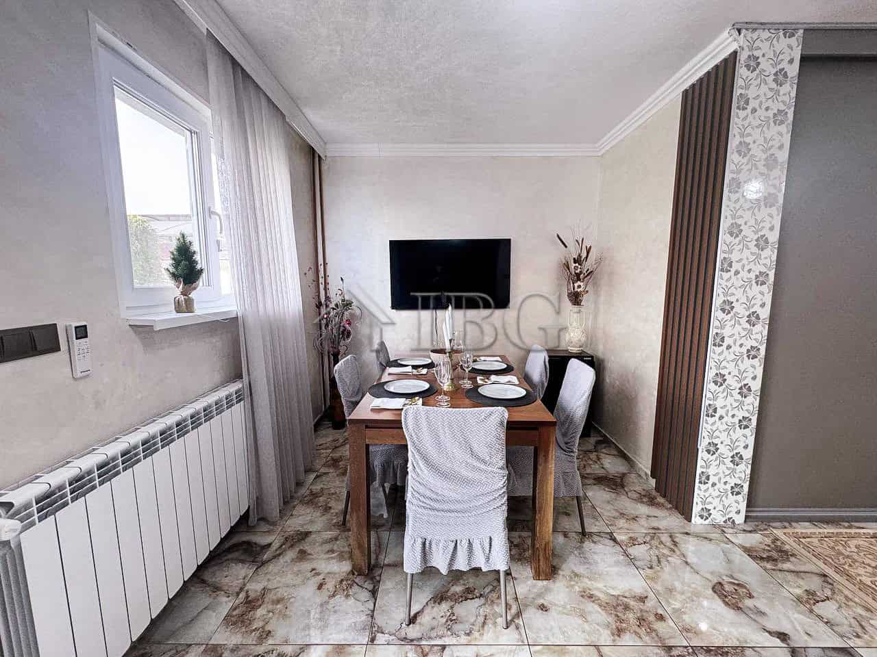 Bright dining area overlooking the sea with elegant decor and modern furnishings. Perfect for family.
