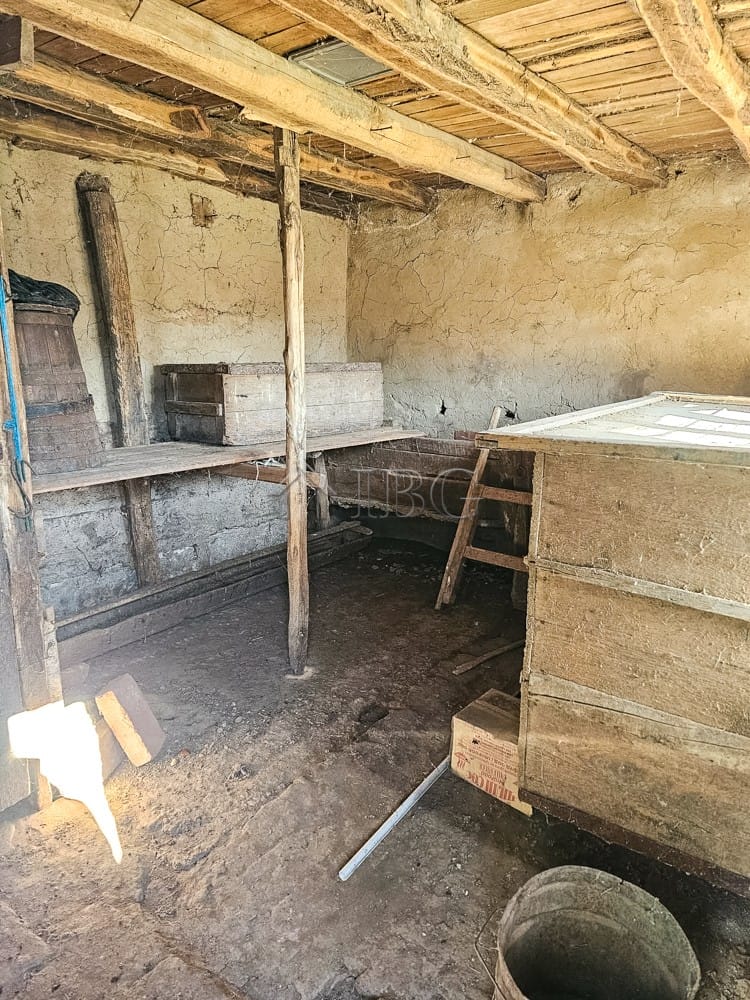 House with rustic interior, large open space, and wooden beams, ideal for renovation and development.