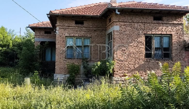House with renovated roof and garden in a peaceful village setting.