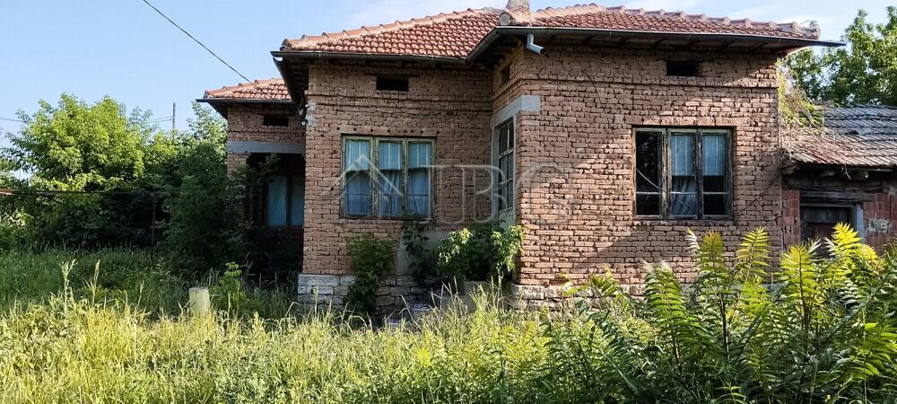 House with renovated roof and garden in a peaceful village setting.