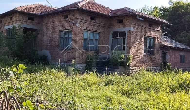 Solid house with a renovated roof in a peaceful village setting.
