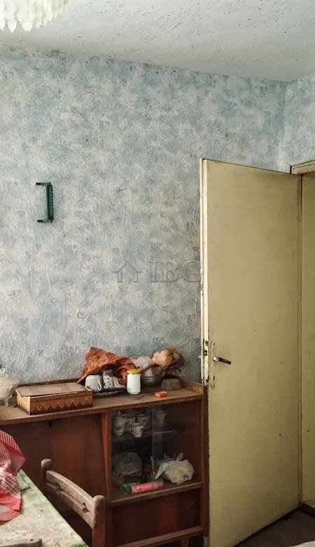 Cozy house interior with renovated roof and simple decor in a peaceful village setting.