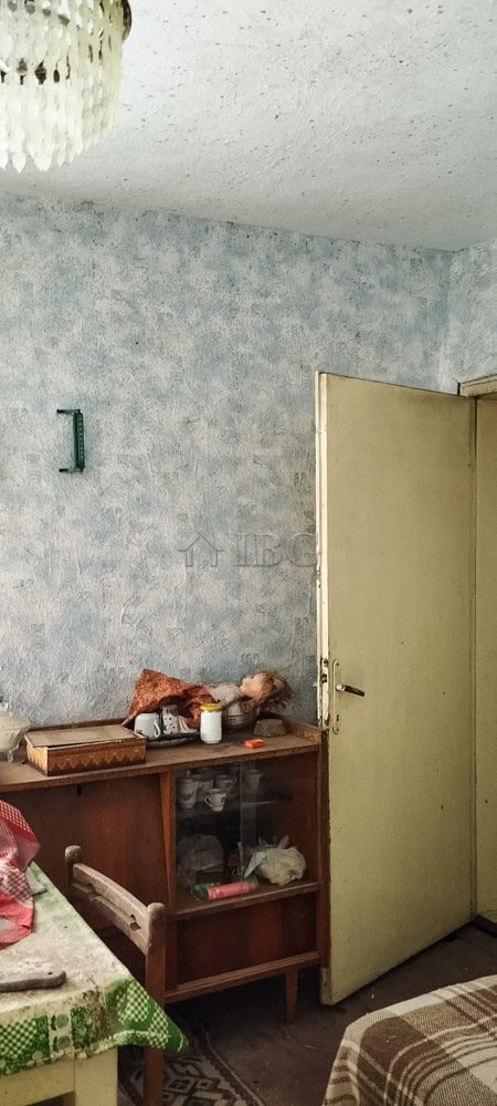 Cozy house interior with renovated roof and simple decor in a peaceful village setting.