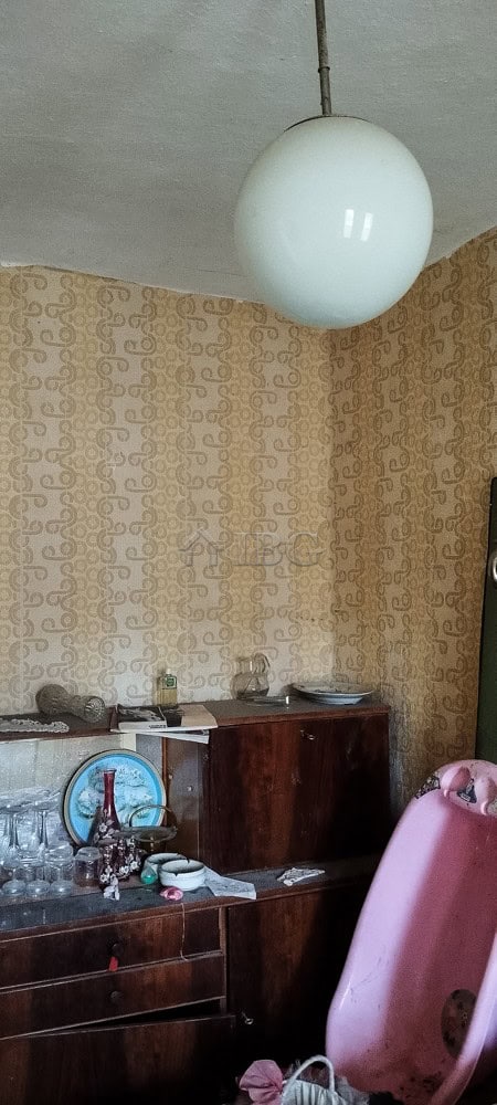 House with renovated roof and vintage interior in a peaceful village setting.