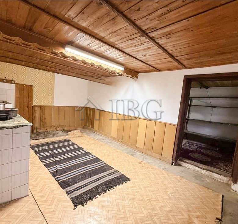 Interior view of a partly renovated house with wooden ceiling and walls near the sea.