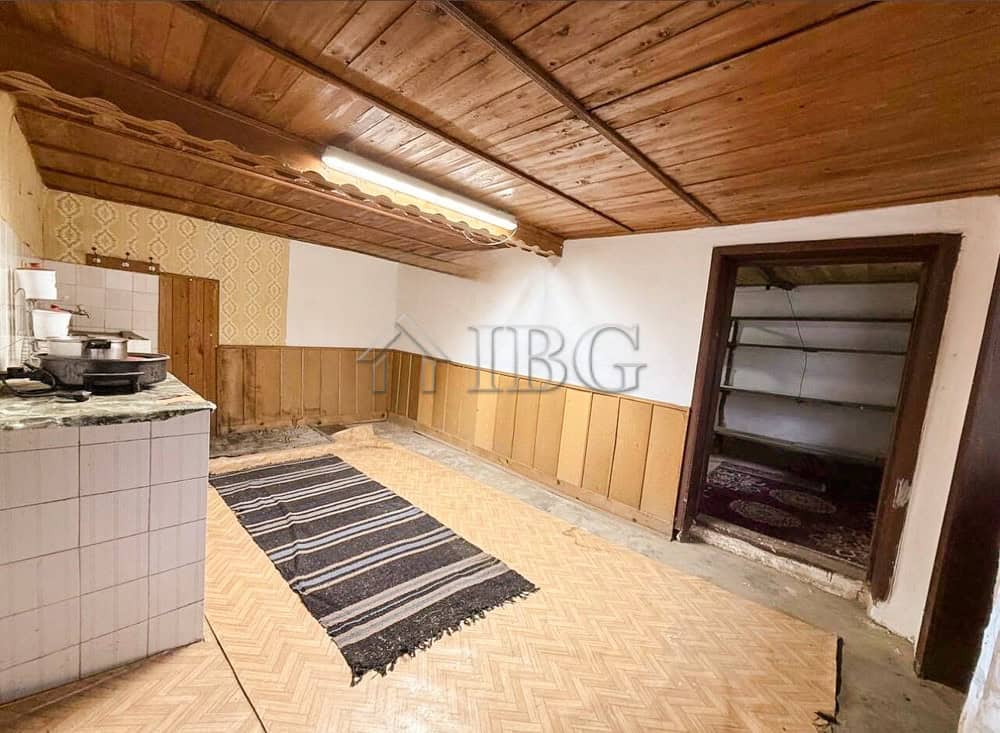 Interior view of a partly renovated house with wooden ceiling and walls near the sea.