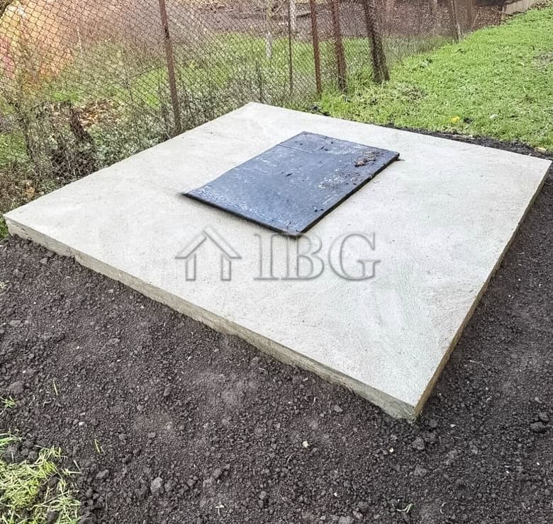 Concrete foundation with access hatch for a partly renovated house near the sea.