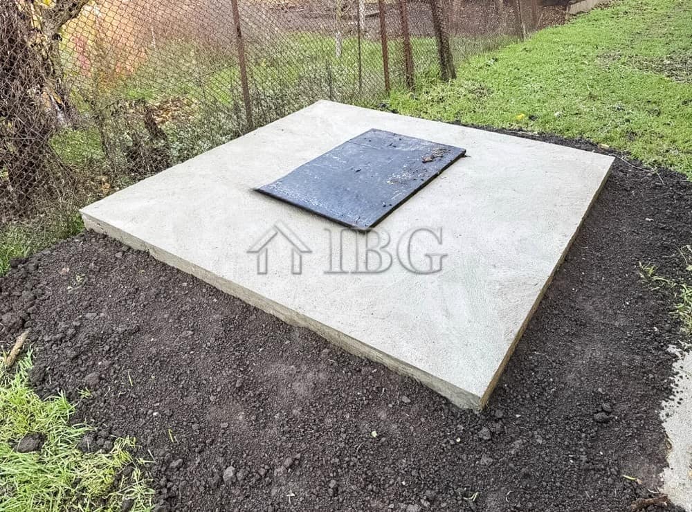 Concrete foundation with access hatch for a partly renovated house near the sea.