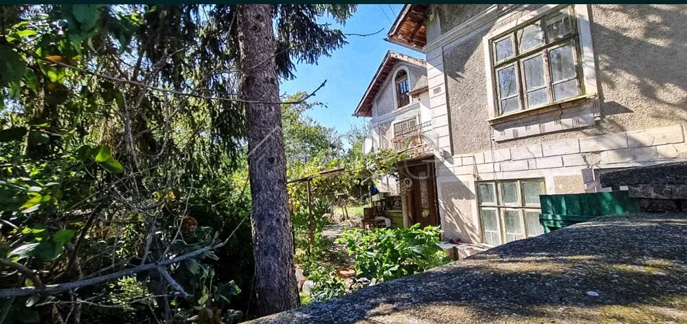 Two-storey house with lush garden and water well in Aleksandrovo village. Ideal for peaceful living.