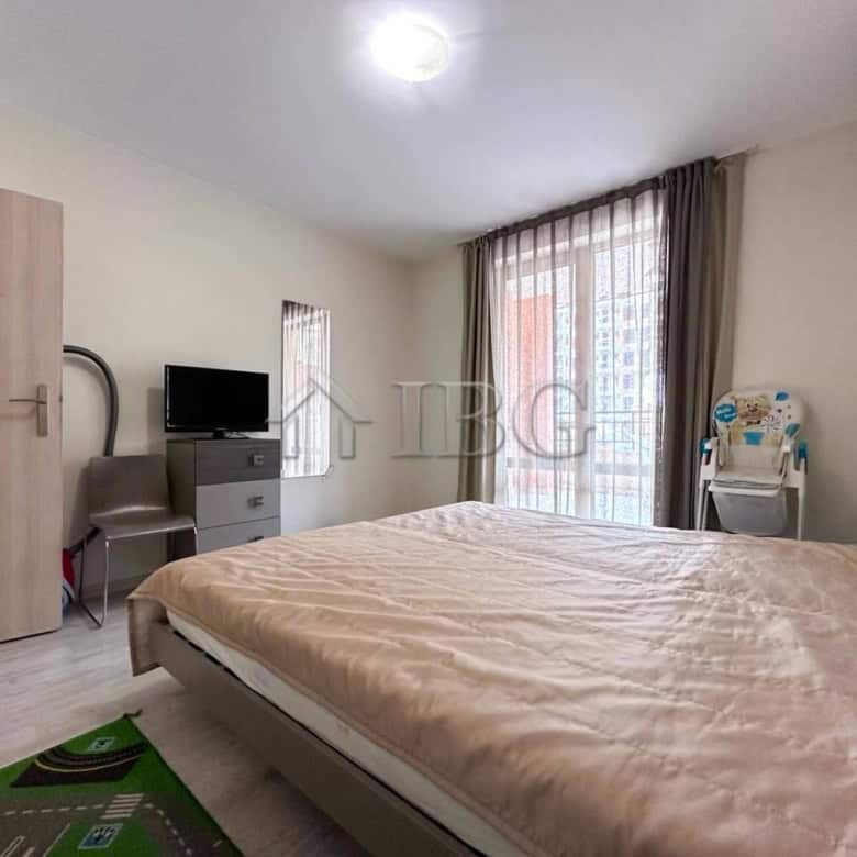 Bright bedroom with large window and balcony access.