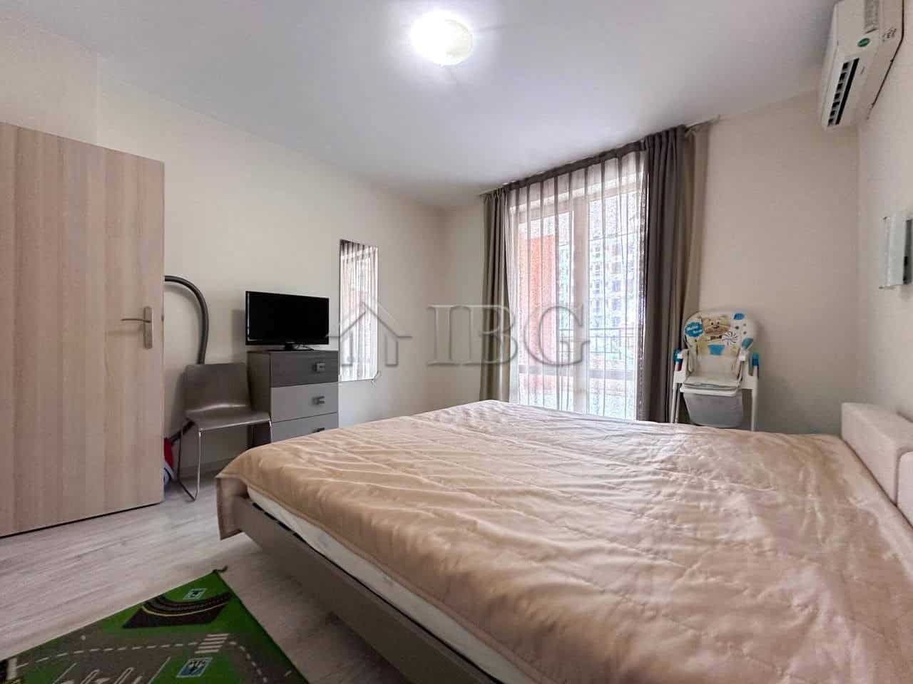 Modern One-Bedroom Apartment in Sveti Vlas Bright bedroom with large window and balcony access.