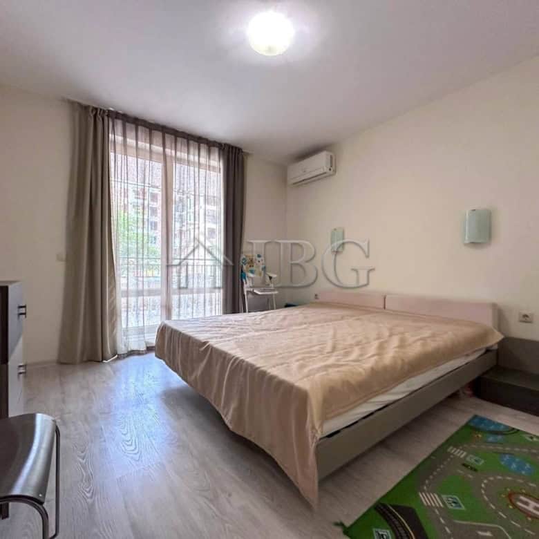Bright bedroom with large window and balcony access.