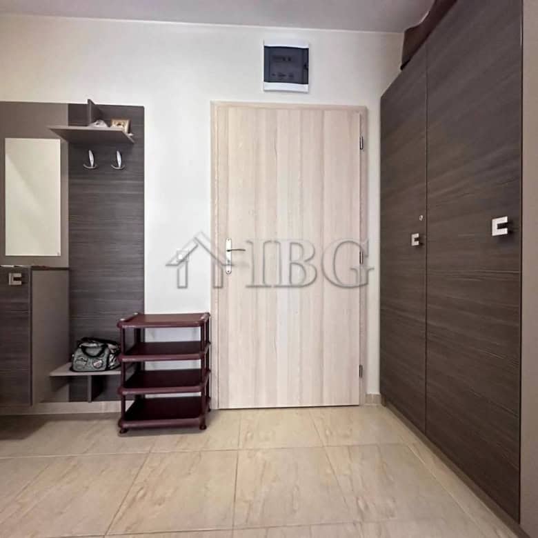 Bright, clean, and well-furnished living space with storage units and a mirror.