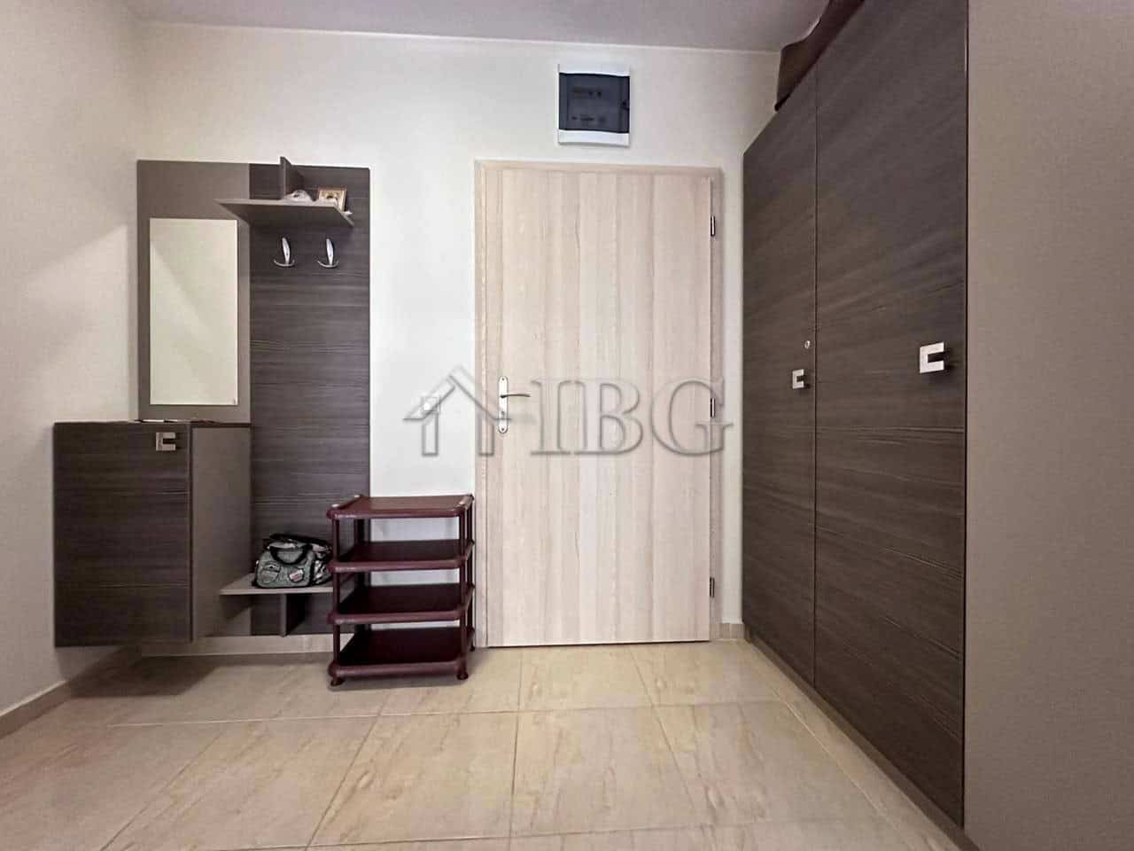 Modern one-bedroom apartment interior in Sveti Vlas, Bulgaria. Bright, clean, and well-furnished living space with storage units and a mirror.