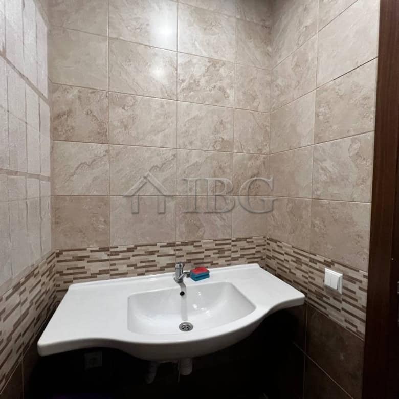 Office bathroom with sink and tiled walls in Burgas, close to Sea Garden.