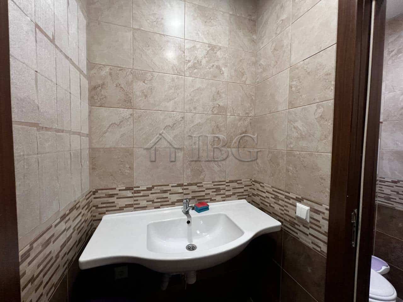 Office bathroom with sink and tiled walls in Burgas, close to Sea Garden.