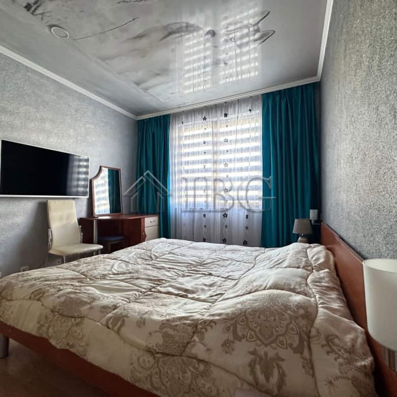 Spacious bedroom in Star Fish Complex, Sveti Vlas, Bulgaria, with modern decor and large window.