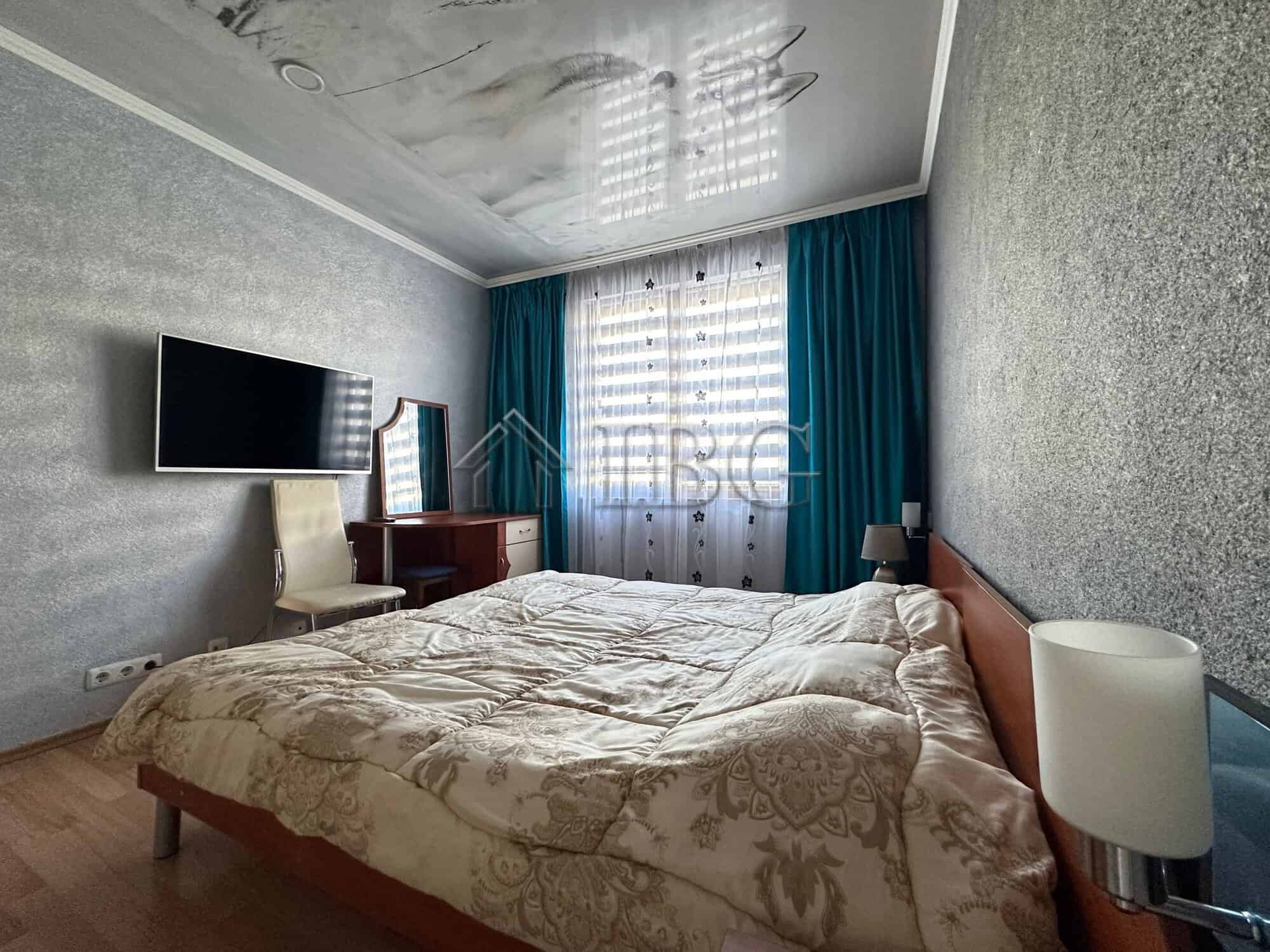 Spacious bedroom in Star Fish Complex, Sveti Vlas, Bulgaria, with modern decor and large window.