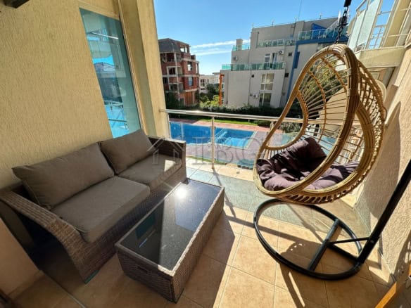 Bright balcony with seating and pool view in Sveti Vlas.