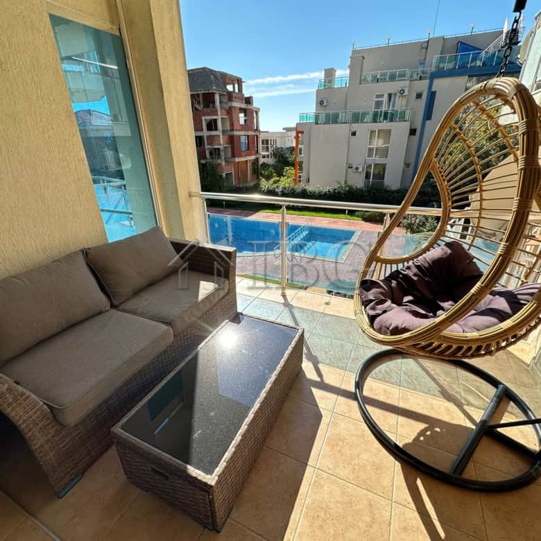 Bright balcony with seating and pool view in Sveti Vlas.