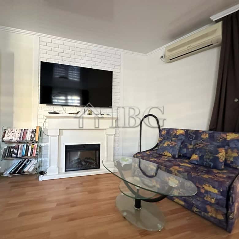 Modern living room with TV, fireplace, and sofa in Sveti Vlas apartment.