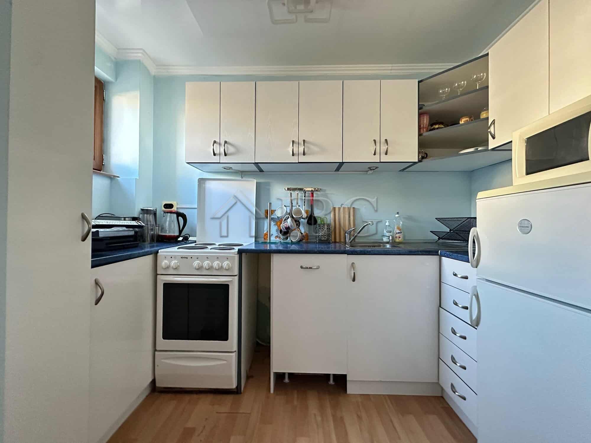 Bright kitchen in Sveti Vlas with modern appliances and ample storage space.