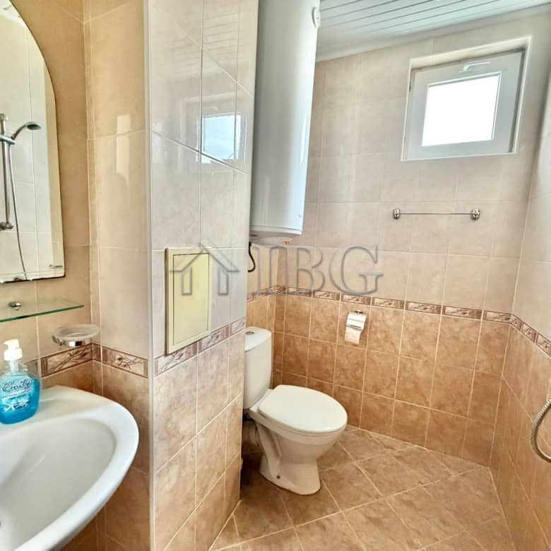 Bright bathroom with shower and window in Sunny Day 3 Complex.