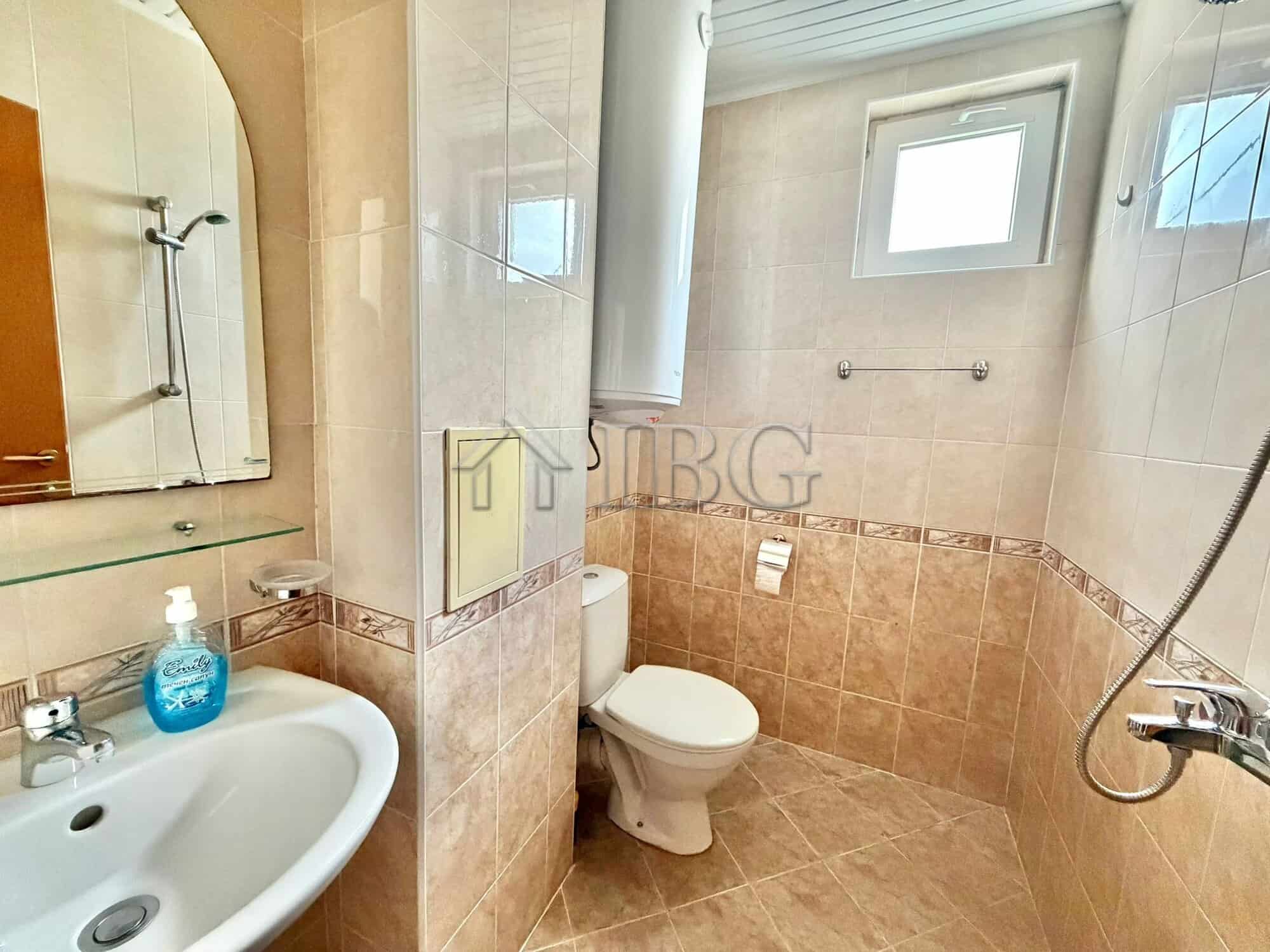 Bright bathroom with shower and window in Sunny Day 3 Complex.