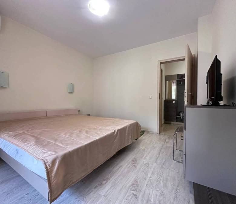 Interior of a 1-bedroom apartment in Sveti Vlas, near the sea, with a large bed and modern furnishin.