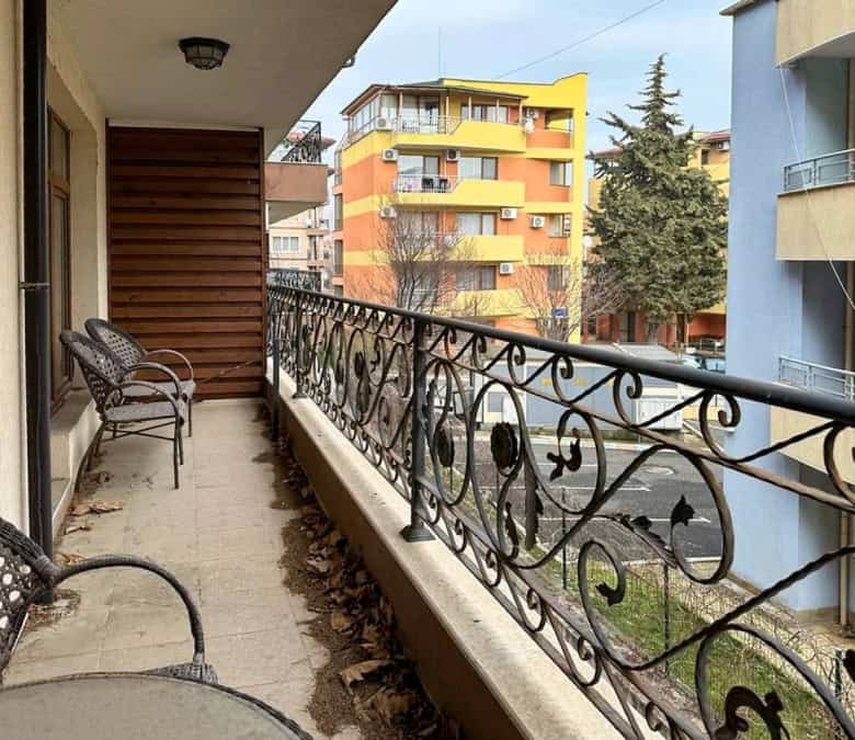 Balcony with sea view in Ravda, Bulgaria, featuring outdoor seating and urban surroundings.