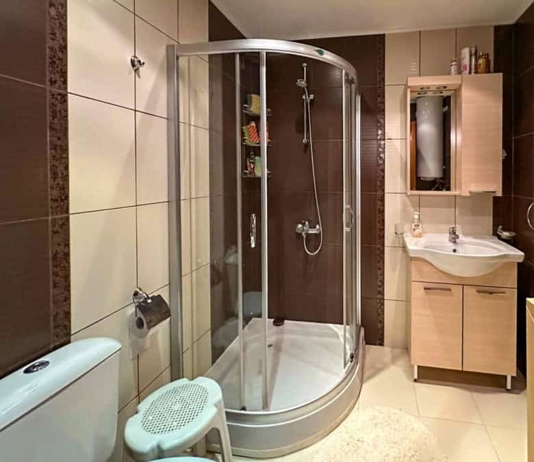 Bright, modern bathroom with shower cabin in a seaside apartment in Ravda.