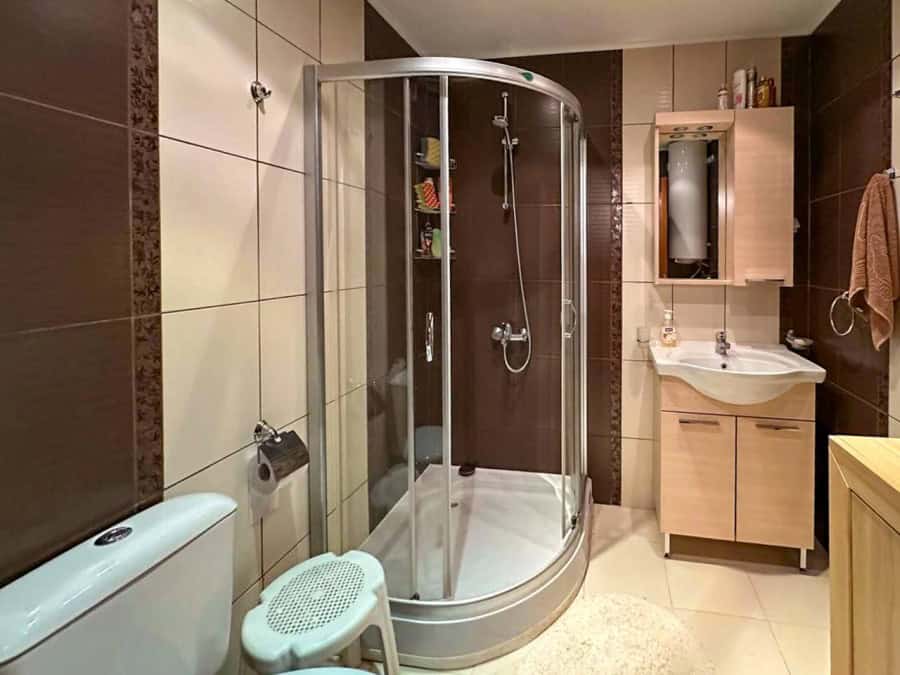 Bright, modern bathroom with shower cabin in a seaside apartment in Ravda.
