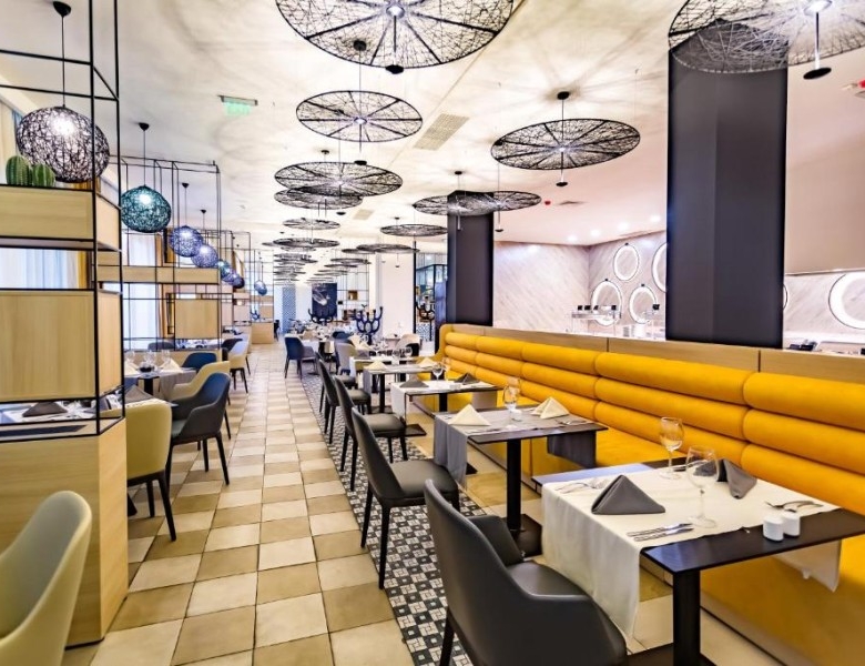 Spacious dining area featuring contemporary furniture and elegant design elements.