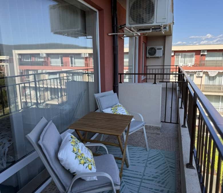 Balcony of a top floor studio in Holiday Fort Club, Sunny Beach, with outdoor seating and city views.