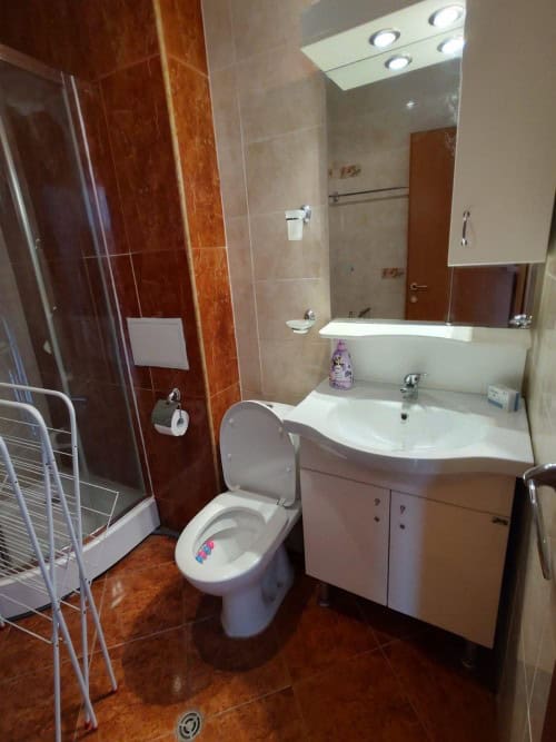 Bright bathroom with toilet, sink, and shower in Holiday Fort Club, Sunny Beach.