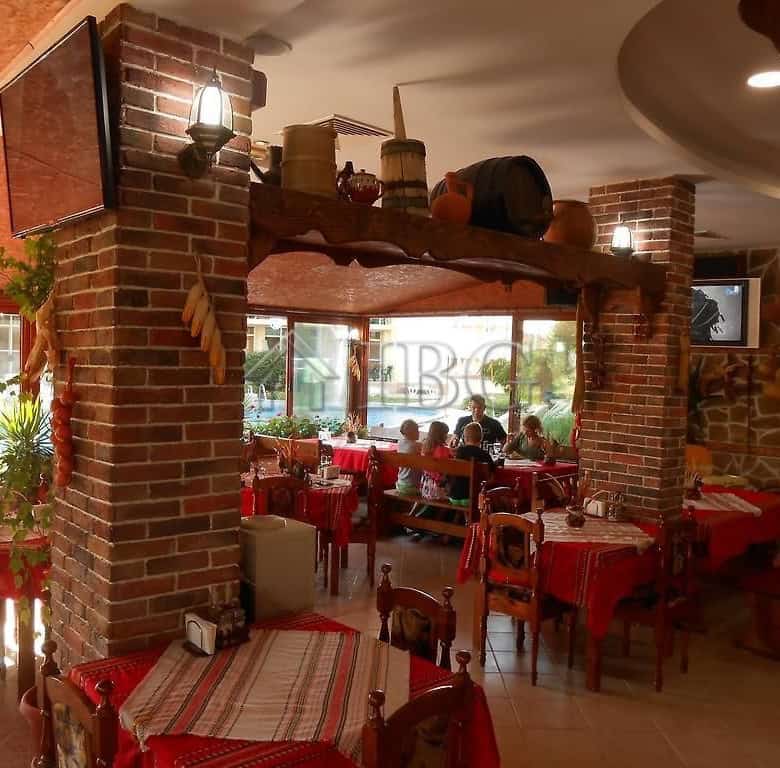 Charming restaurant with brick pillars and warm lighting, perfect for dining in a relaxed, inviting.
