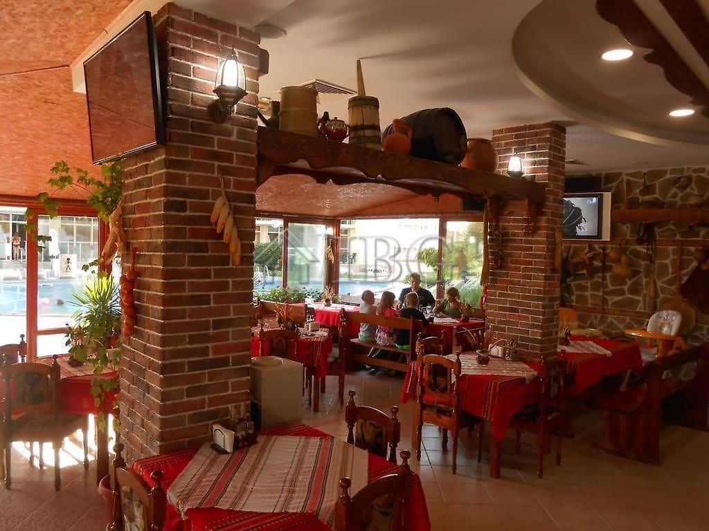 Charming restaurant with brick pillars and warm lighting, perfect for dining in a relaxed, inviting.