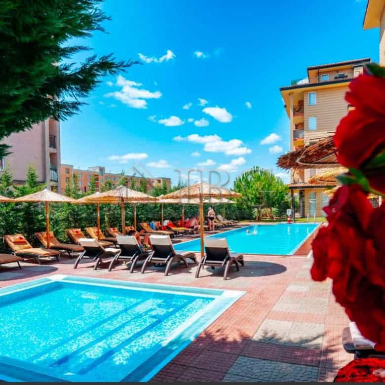 Pool area at Sunny View Central, Sunny Beach with sun loungers and umbrellas for relaxation.