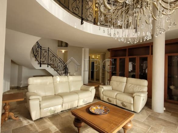 Elegant living room with cream sofas and grand chandelier in Sveti Vlas.