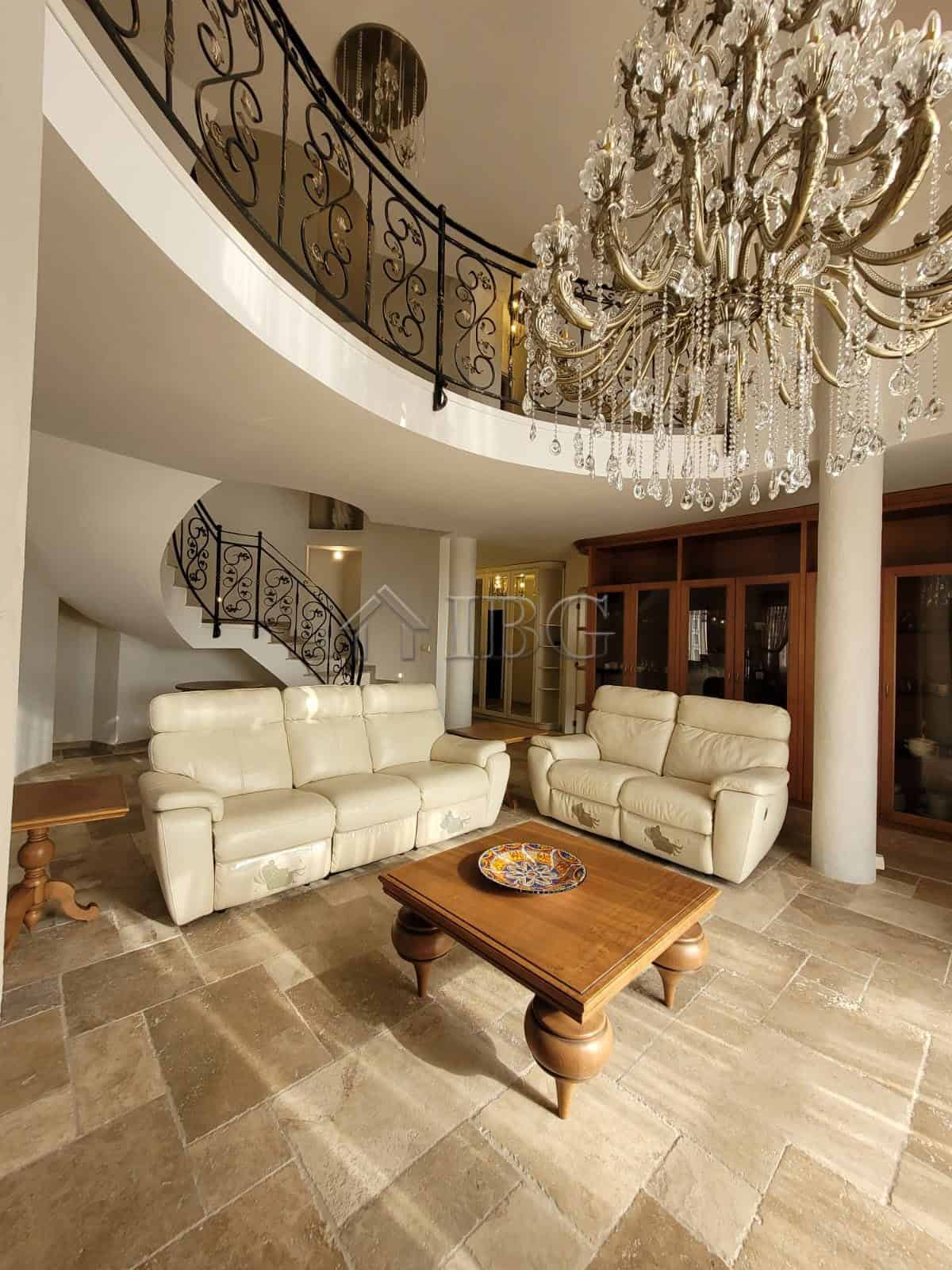 Elegant living room with cream sofas and grand chandelier in Sveti Vlas.